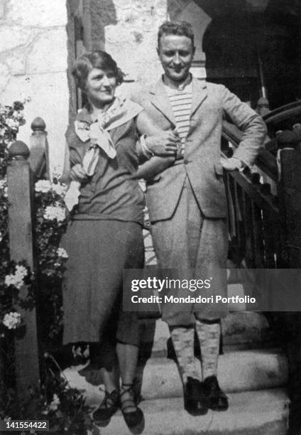 The American writer Francis Scott Fitzgerald and his wife Zelda Sayre posing arm in arm on a staircase. 1926