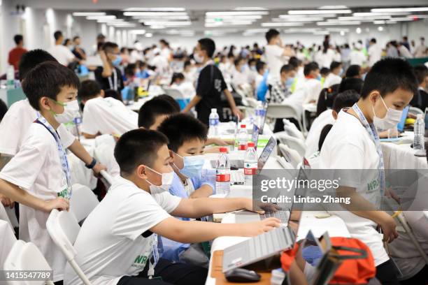 Young children experience robot courses during the 2022 World Robot Conference at Beijing Etrong International Exhibition on August 18, 2022 in...