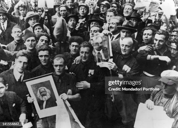 Group of Fascist Blackshirts is about to set fire to portraits of Marx and Lenin during the elections of May 1921. Italy, May 1921