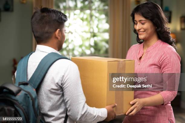 receiving a delivery from the mailman stock photo - home delivery stock pictures, royalty-free photos & images