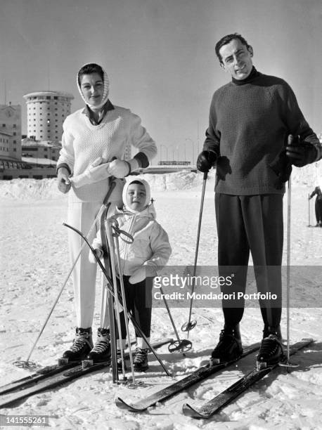 Italian cyclist Fausto Coppi posing on a ski slope of Sestriere, with his son Angelo Fausto Giulia Occhini, the White Lady. Sestriere, January 1959
