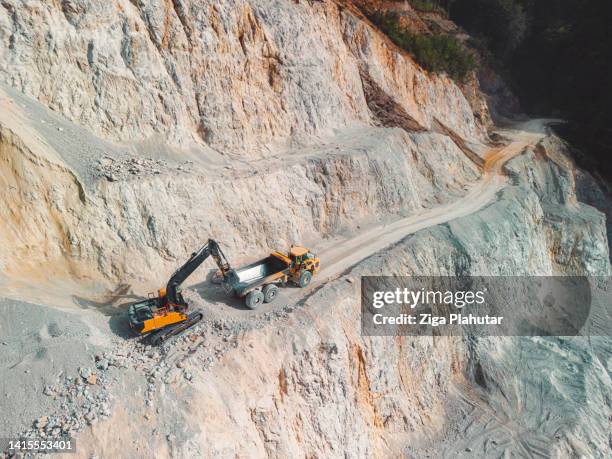 excavator loading gravel on the dump truck - excavation machine stock pictures, royalty-free photos & images