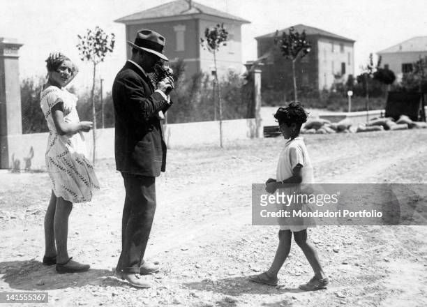 The Italian Head of Government Benito Mussolini and his daughter Edda are given a bouquet of flowers. Cattolica, 1925