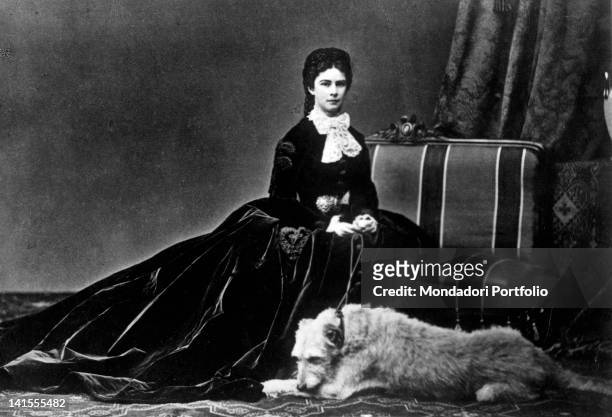 Empress Elizabeth of Bavaria, known as Princess Sissi, posing next to a dog. 1860s