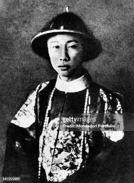 The last emperor of China Pu Yi posing with traditional clothes. 1920s