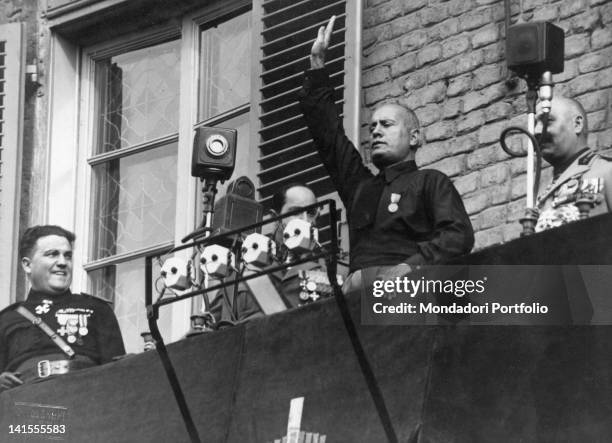 Benito Mussolini greeting the crowd at a rally in Piazza Castello along with Achille Starace and Cesare Maria De Vecchi. Turin, 23rd October 1932