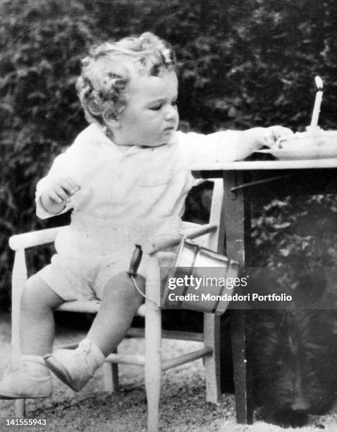 The young Charles Lindbergh Junior sitting on a chair during his first birthday. USA, 1931