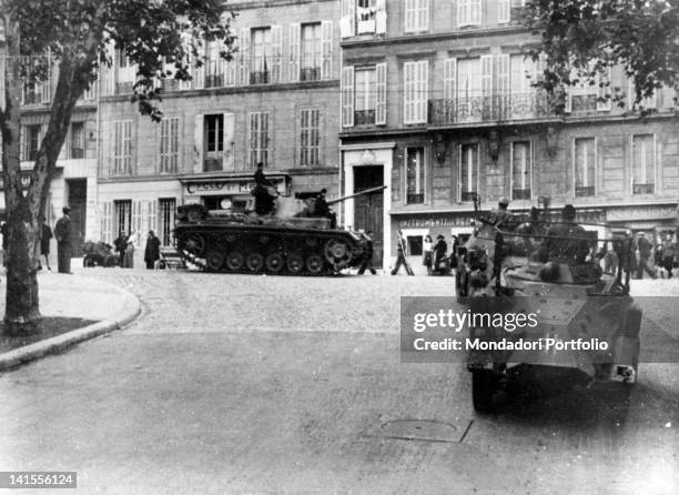 German tanks and armoured vehicles travelling along a Marseille street. Marseille, November 1942