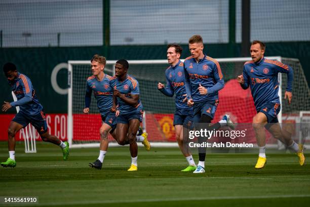 Ethan Galbraith, Tyrell Malacia, James Garner, Scott McTominay, Christian Eriksen of Manchester United in action during a first team training session...