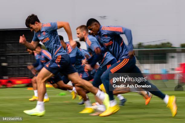 Harry Maguire, Marcus Rashford of Manchester United in action during a first team training session at Carrington Training Ground on August 17, 2022...