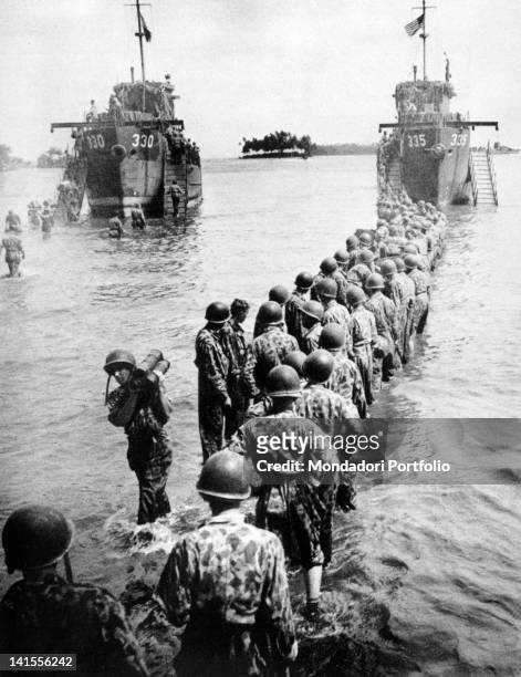 Long line of U.S. Marines transporting munitions from the ships to the shore on the island of Rendova. Rendova, Solomon Islands, June 1943