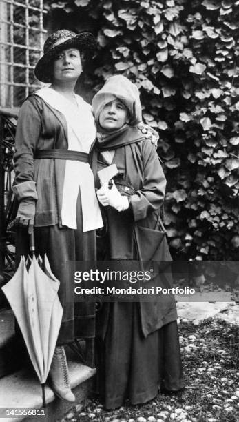 The Italian actress Eleonora Duse posing with French colleague Cecile Sorel in a garden. 1916
