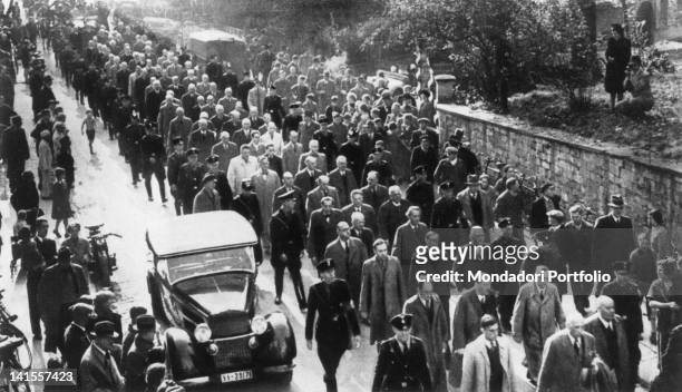 Large group of Jews, escorted by soldiers of the SS, are taken to a concentration camp before the eyes of the crowd at the roadside. Berlin, 1934