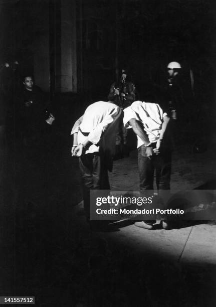 Two Afro-Americans being handcuffed and arrested by policemen following race riots. Los Angeles, August 1965