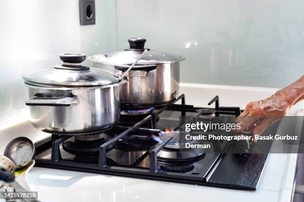 cooking on a gas hob - cooking gas stock pictures, royalty-free photos & images