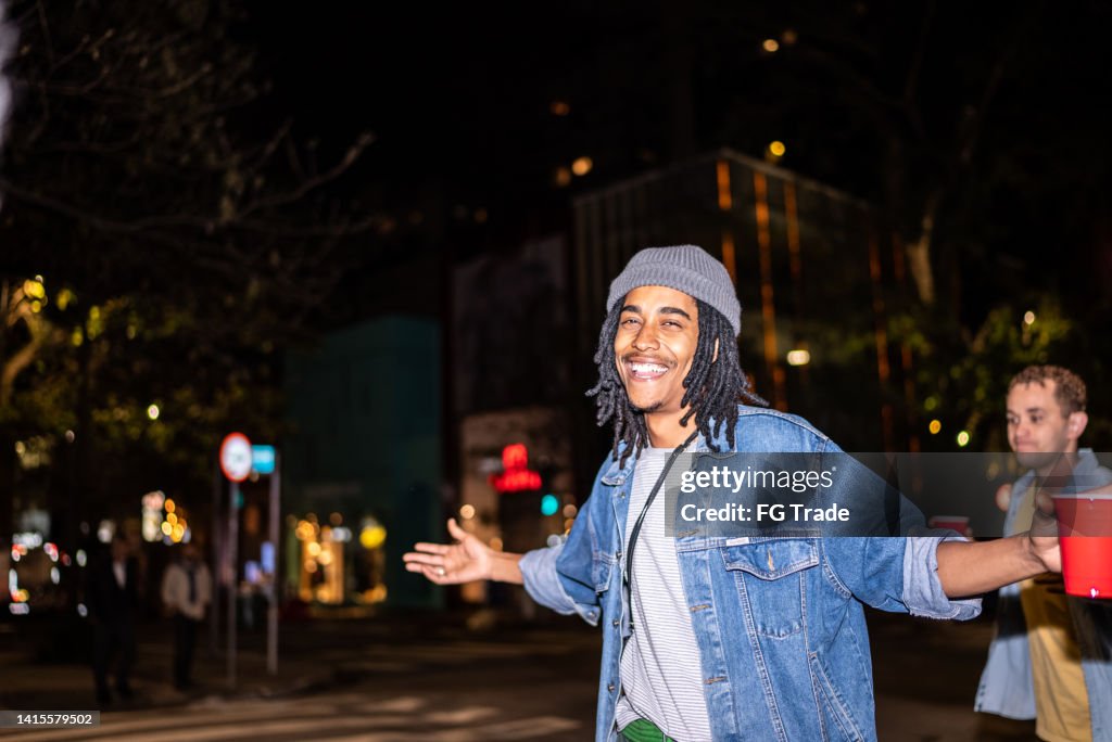 Portrait of a happy man with disposable cup in a party