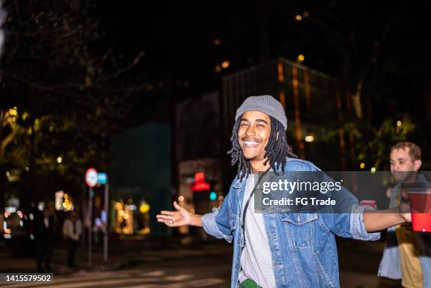 portrait of a happy man with disposable cup in a party - camera flashes stock pictures, royalty-free photos & images