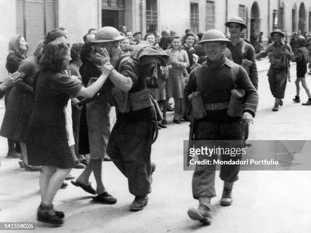 British soldiers of the Eighth Army cheered by civilians while going along the streets of Ferrara. Ferrara, 24th April