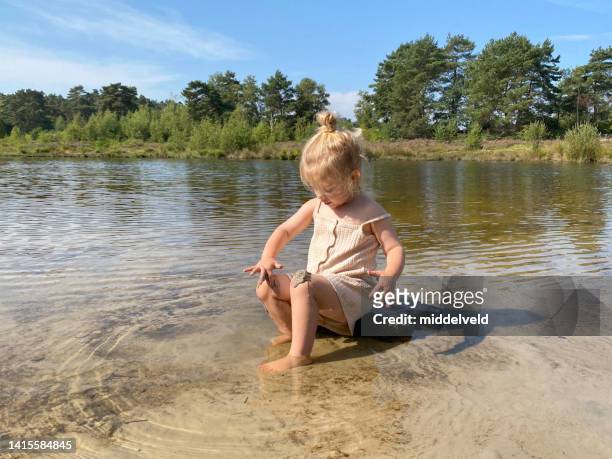 toddler girl playing in the water - heather brooke stock pictures, royalty-free photos & images