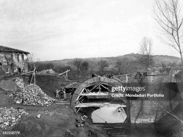 Italian civilians rebuilding a bridge on behalf of Allies near Florence. Tuscany, 3rd December 1944