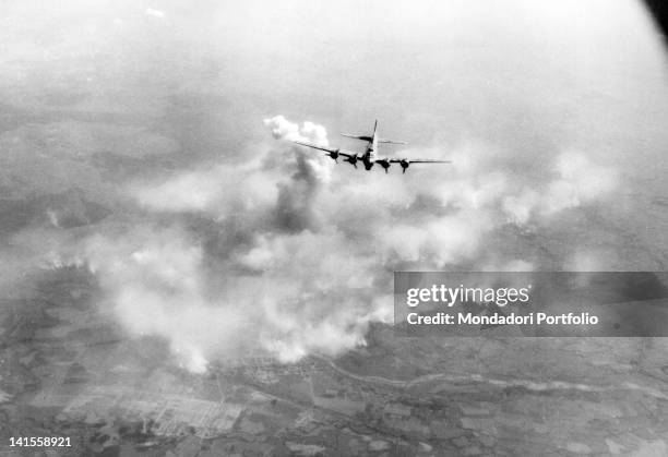 Flying Fortress flying over the fires of the oil refineries of the Polish town Oswiecim. Oswiecim, 20th August 1944