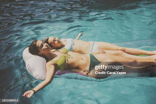 sibling having fun  in the pool during summer time - cousins stock pictures, royalty-free photos & images