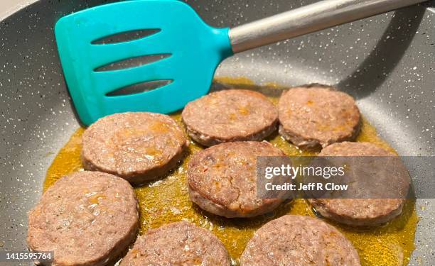 cooking fresh sausage patties - processed meat stock pictures, royalty-free photos & images
