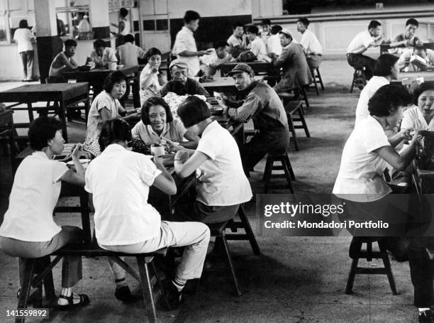 Textile factory worker women standing in a the factory dining hall in a urban commune. Beijing, 1960s