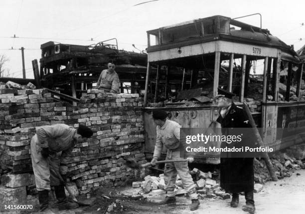 Near the Brandenburg Gate, soldiers of the German army make barricades by filling trams with bricks. Berlin, April 1945