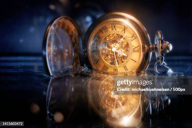 close-up of illuminated light bulb on table - uhrzeiger stock-fotos und bilder