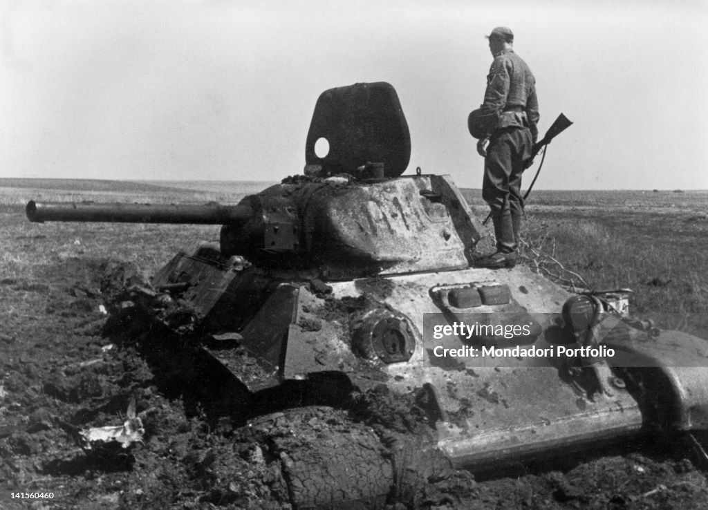 Soldier Watching A Destroyed Tank