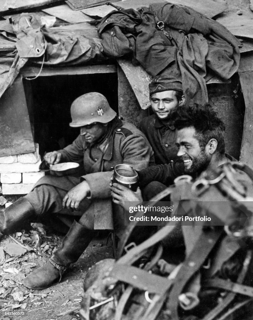 German Emergency Rations Soldiers of the German Army eating rations among the ruined walls of ...