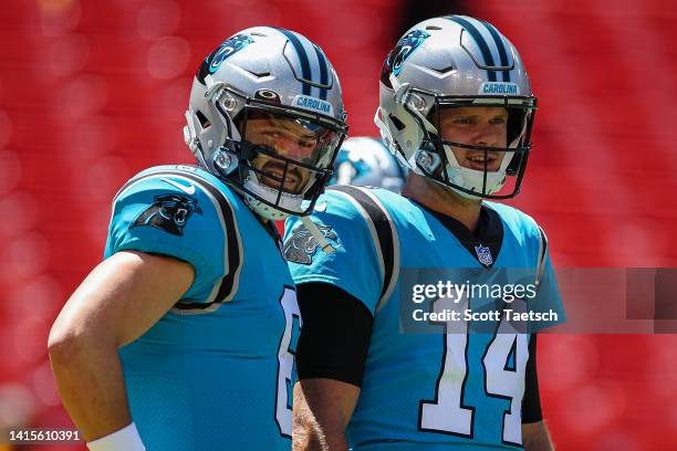 Baker Mayfield and Sam Darnold of the Carolina Panthers interacts before the preseason game against the Washington Commanders at FedExField on August...