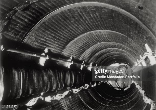 An American B-29 Superfortress crew member passing through a not pressurized tunnel during a drill. Seattle, January 1945