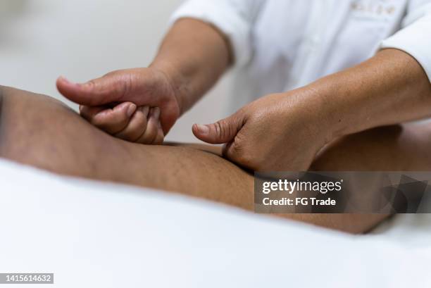 aesthetician massaging a costumer at a beauty spa - fat massage stock pictures, royalty-free photos & images