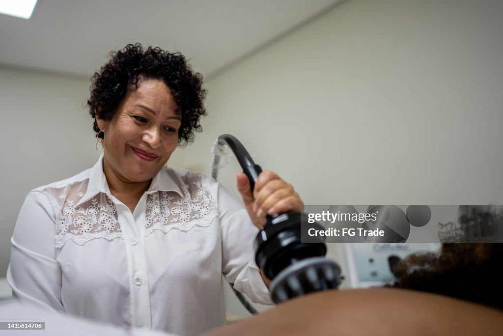 Esteticista haciendo un tratamiento de belleza a un cliente en un spa
