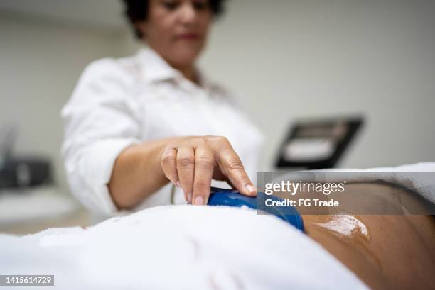 aesthetician doing a beauty treatment on a customer at a spa - flaccid stock pictures, royalty-free photos & images