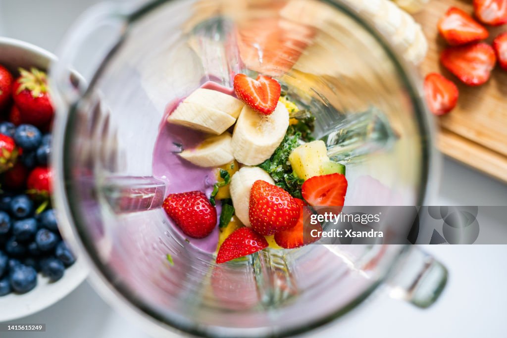 Fruit smoothie ingredients in a blender