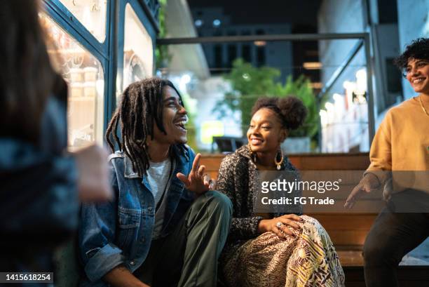 friends having fun outdoors at night - group of black people stockfoto's en -beelden