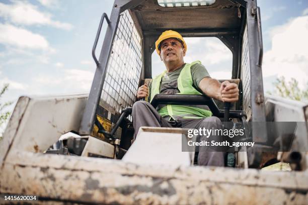 mature small excavator operator - construction vehicles bildbanksfoton och bilder