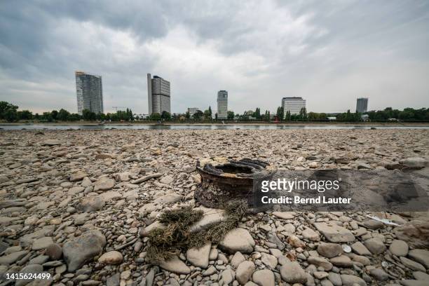 Rusty wheel rim lies on dried-up shore of the Rhein river on August 17, 2022 in Bonn, Germany. Germany is facing a persistently hot and dry summer...