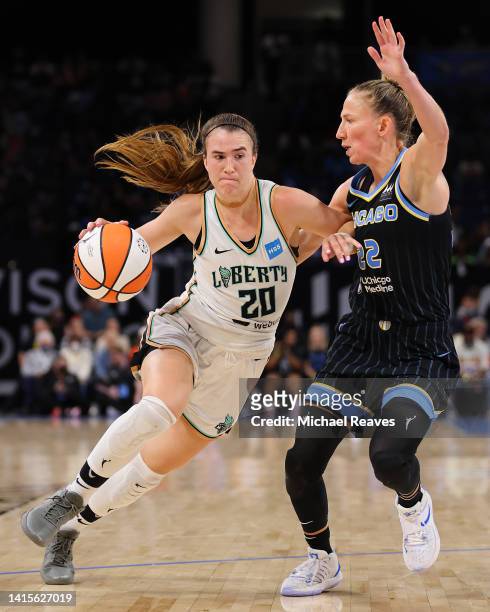 Sabrina Ionescu of the New York Liberty drives to the basket against Courtney Vandersloot of the Chicago Sky during the second half in Game One of...