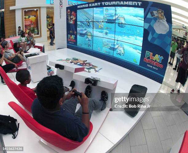 Children and some adults play video games on Nintendo 2DS during the Play Nintendo Tour 2014 inside Westfield Mall, June 6, 2014 in Culver City,...