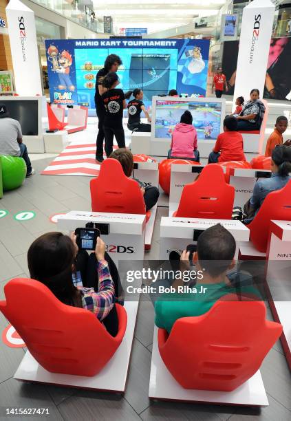 Children and some adults play video games on Nintendo 2DS during the Play Nintendo Tour 2014 inside Westfield Mall, June 6, 2014 in Culver City,...