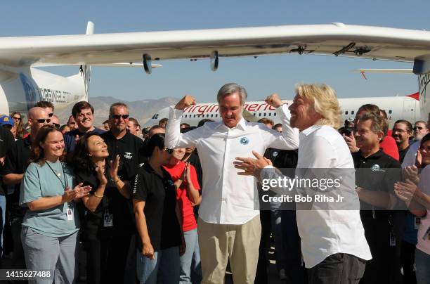 Sir Richard Branson and aviation pioneer Burt Rutan with team members during the official roll-out of Virgin Galactic's 'WhiteKnightTwo' spaceship...