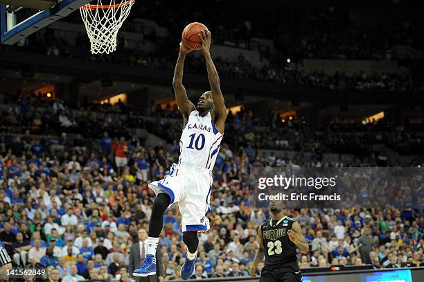 Tyshawn Taylor of the Kansas Jayhawks dunks in the second half against Lewis Jackson of the Purdue Boilermakers during the third round of the 2012...