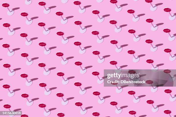 toy white plastic stop traffic signs pattern on pink background. concept of driving, car, transport, prohibition, stop, highway code and end. - code pink stock pictures, royalty-free photos & images