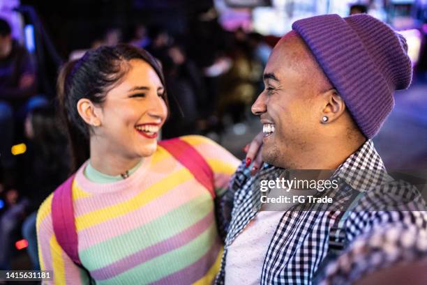 young couple (or friends) looking at each other outdoors at night - including a transgender person - gay men pic stock pictures, royalty-free photos & images