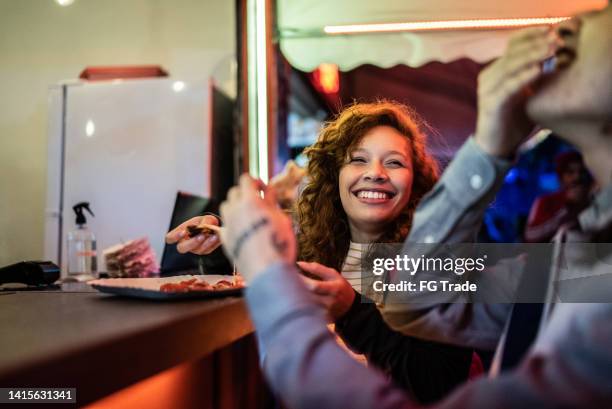 friends eating pizza outdoors at night - touring music festival stock pictures, royalty-free photos & images