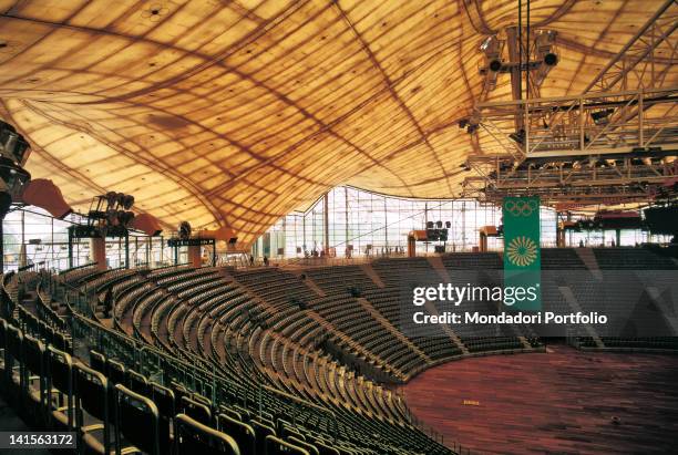 View of the inside of one of the Olympic venues built in Munich; detail of empty stands and covering structures in the gymnastics stadium. Munich,...